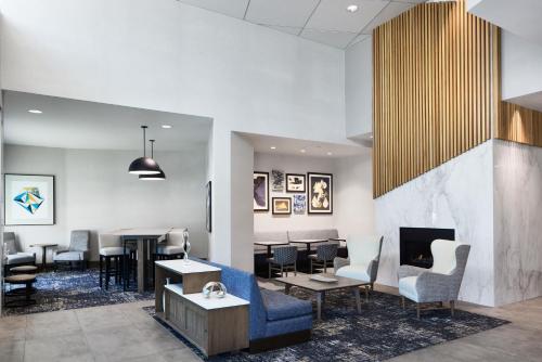 a waiting room with chairs and a fireplace at Hyatt Place Salt Lake City Downtown / The Gateway in Salt Lake City