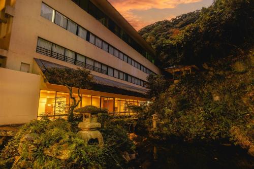 a building with a garden in front of it at ホテル偕幸 in Tokushima