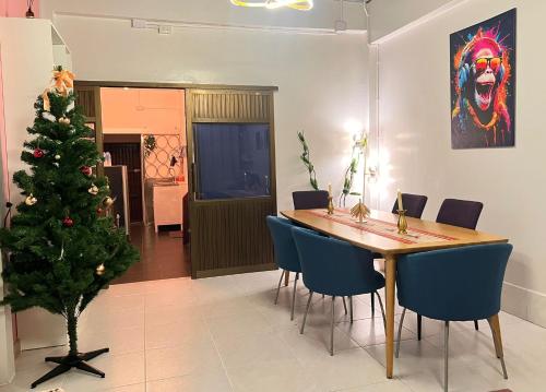 a dining room with a christmas tree and a table and chairs at LA CASA in China town in Bangkok