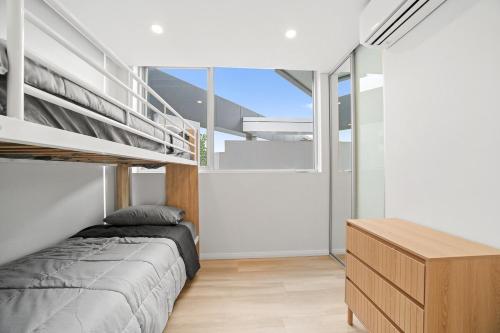 a bedroom with a bunk bed and a desk at Luxury 2Bed 2bath Apartment with Distance Harbour Bridge View 6km from CBD in Sydney