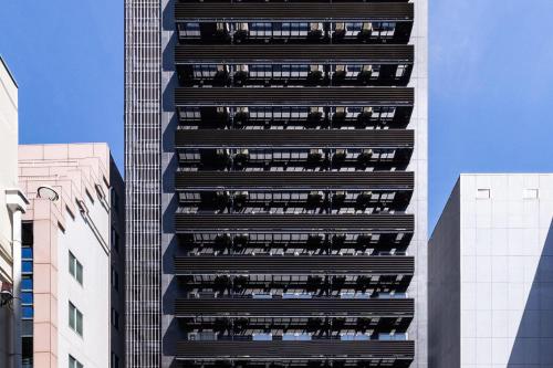 a tall building with balconies on the side of it at Comfort Hotel Shin-Osaka in Osaka