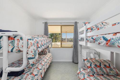 a room with two bunk beds and a window at Packem Inn in Lancelin