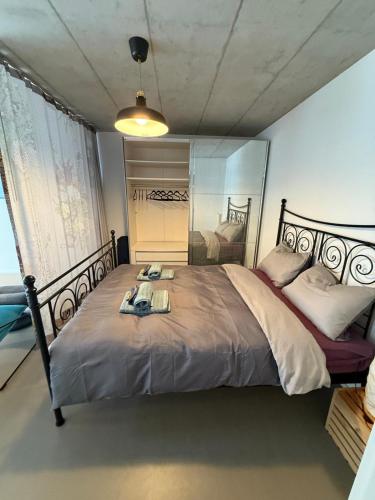 a bedroom with a large bed with a mirror at Studio Happy Life Mountainview 5min Thun -25min Interlaken in Blumenstein