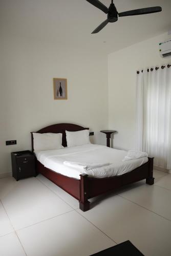 En eller flere senge i et værelse på Tamarind Heritage Holiday Home