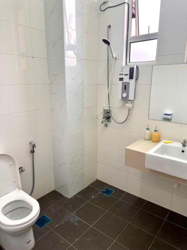 a bathroom with a shower and a toilet and a sink at HOMESTAY Mu in Simpang Ampat