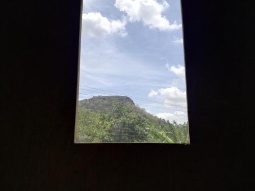 a window with a view of a mountain at Sigiri Forest View in Sigiriya