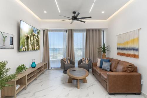 een woonkamer met een bank en een tafel bij Encantmame Soleil 1BR lockoff sleeps 4 in Playa Encanto