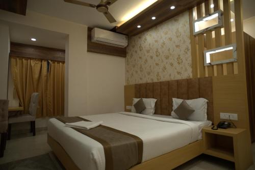 ein Schlafzimmer mit einem großen Bett in einem Zimmer in der Unterkunft Hotel Sonali Golden Palace in Bhubaneshwar