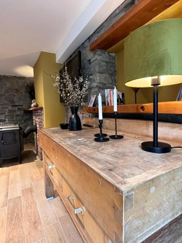 a wooden counter with two candles on top of it at Domaine de Hurlevent - Gite 10 personnes - Le Refuge in Aywaille