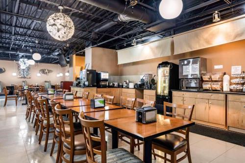 a row of tables and chairs in a restaurant at Rodeway Inn & Suites Fort Lauderdale Airport & Cruise Port in Fort Lauderdale