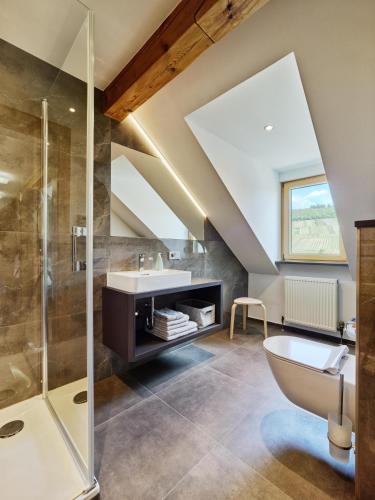 a bathroom with a sink and a shower at Weingut Schumann in Lieser