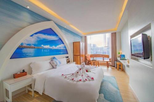 a bedroom with a white bed and a large window at Huangma Holiday Nanhai Museum Hotel in Haikou