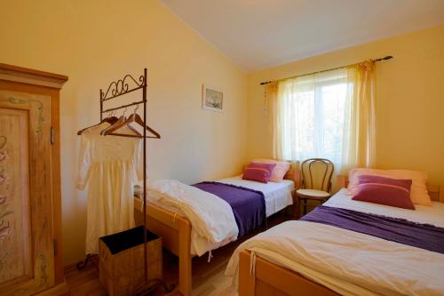 a bedroom with two beds and a window at House Moreda by Istrialux in Vodnjan