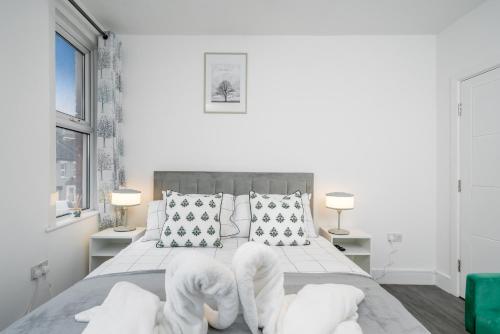 En eller flere senge i et værelse på Gem In Ilford