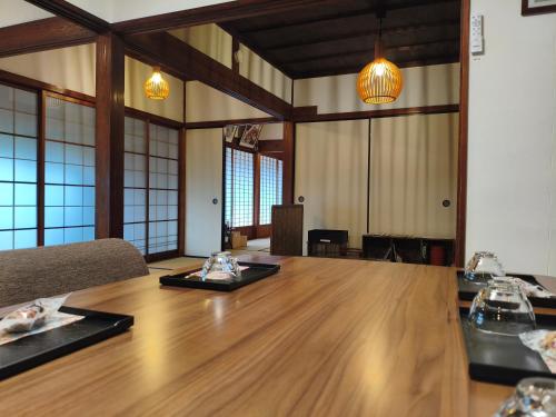 a large conference room with a large wooden table at 釜炒り茶の宿陽だまりTraditional Japanese house near Kumano Kodo and Nachi Falls with parking bikes garden and onsite tea house in Nachikatsuura