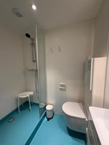 a bathroom with a toilet and a glass shower at Hotel Xabina Javea in Jávea