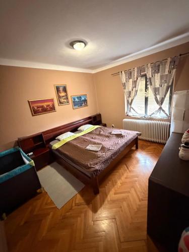 a bedroom with a bed and a window at LakePark Garden Villa with swimming pool & park in Bekecs