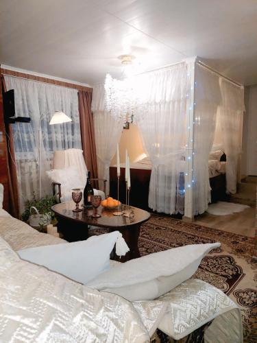 a bedroom with a bed and a table with candles at Тиха гавань в чарівному містечку in Korsun'-Shevchenkivs'kyy