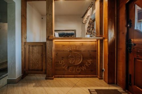 a hallway with a wooden door with graffiti on it at Willa Sulejowka in Poronin