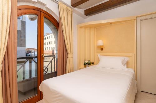 En eller flere senge i et værelse på Hotel Giudecca Venezia
