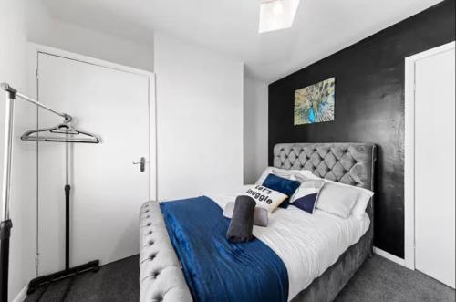 a bedroom with a large bed with blue and white pillows at Spacious 3 bedroom home, sleeps 8, Parking, Central Rochester in Rochester