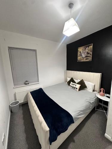 a bedroom with a bed with a blue blanket on it at Spacious 3 bedroom home, sleeps 8, Parking, Central Rochester in Rochester
