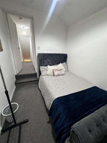 a bedroom with a bed with a blue blanket at Spacious 3 bedroom home, sleeps 8, Parking, Central Rochester in Rochester