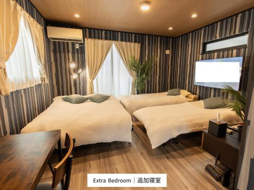 En eller flere senge i et værelse på 貸切新築ヴィラ l 最大9名 l 小田原城徒歩14分 l 無料P l 箱根板橋駅徒歩9分 l Private Villa Minamicho Odawara