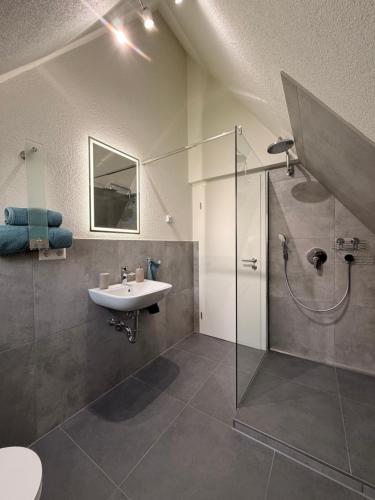 a bathroom with a sink and a shower at Pension Elisa in Bad Friedrichshall