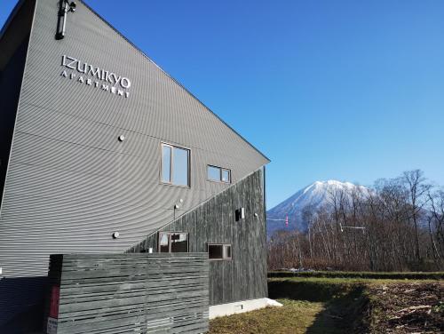 a building with a sign on the side of it at Niseko Izumikyo in Kutchan