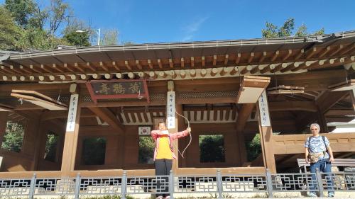 two people standing in front of a building at Lydia Craft Guesthouse in Seoul