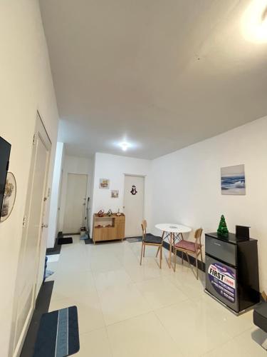 a living room with a table and a dining room at Selah Stay in Manolo Fortich