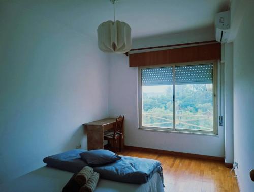 En eller flere senge i et værelse på Cantinho da Paz - Apartamento completo t3