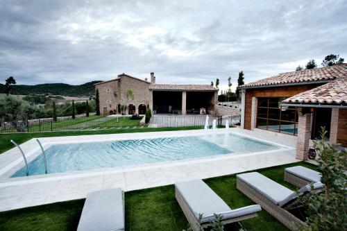 a swimming pool in the yard of a house at Casa Rural Cirera D'Avall in Lladurs