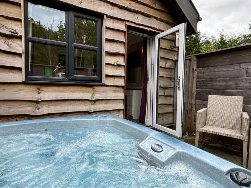 a hot tub in the backyard of a house at Hare Lodge with Hot Tub in Cupar