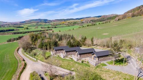 an aerial view of a home in a field at Hedgehog Lodge with Hot Tub in Cupar