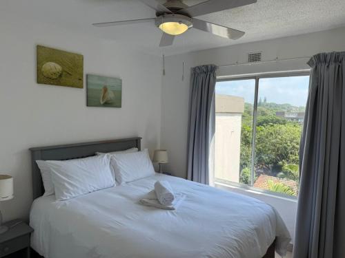 a bedroom with a bed with a large window at 222 Laguna La Crete in Margate