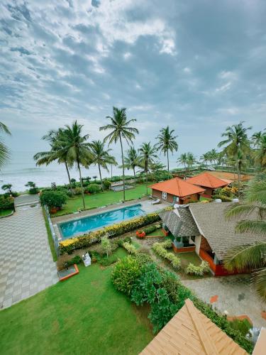 an aerial view of a resort with a swimming pool at Asokam Beach Resort in Kannur