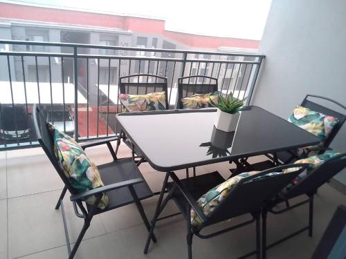 a table and two chairs on a balcony at Empire Investments Mbabane in Mbabane