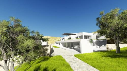 een wit huis met groen gras en bomen bij Fenici Levanzo Hotel - Adults Only in Levanzo