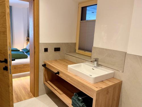 a bathroom with a sink and a mirror at Apartment Winkl 65 in Maria Alm am Steinernen Meer