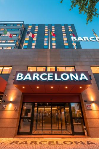 a large building with a sign on the front of it at Hotel 3K Barcelona in Lisbon