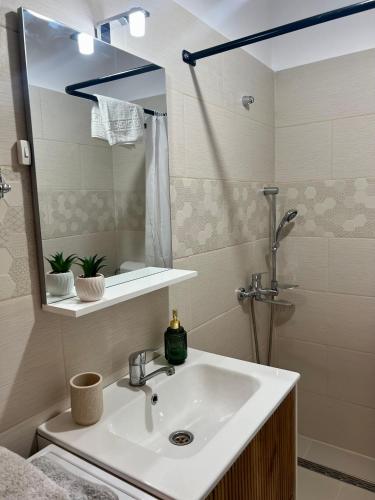 a bathroom with a sink and a mirror at Parc Vatra Dornei - Deluxe Suite in Vatra Dornei