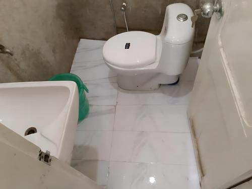 ein weißes Badezimmer mit Toilette und Waschbecken in der Unterkunft Hotel The Prime in Rawalpindi