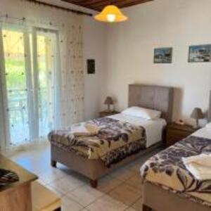 Ένα ή περισσότερα κρεβάτια σε δωμάτιο στο Poseidon Beach Bar & Restaurant Apartments