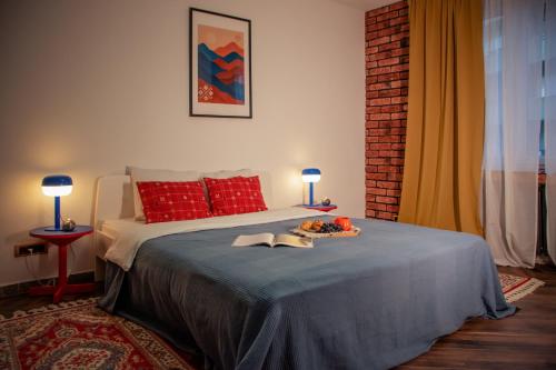 a bedroom with a bed with a tray of food on it at Balkan Charm - Private Parking in Belgrade