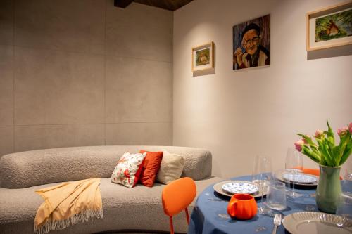 a living room with a couch and a table at Balkan Charm - Private Parking in Belgrade