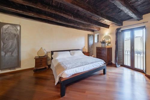 a bedroom with a bed and a large window at Dimora Paradiso in Campobasso
