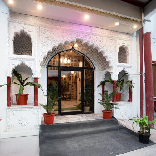 an entrance to a building with potted plants at Stamps By Eight Continents, Pushkar in Pushkar