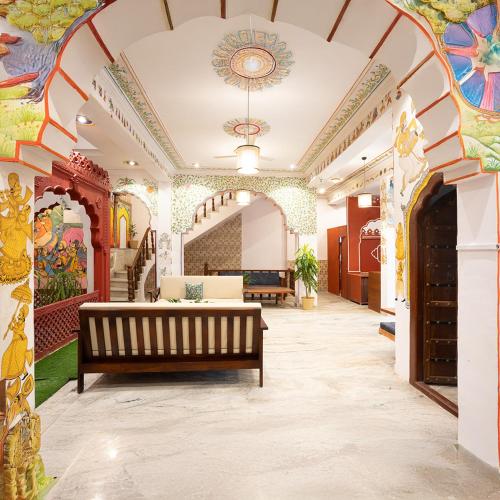 a lobby with a bench in the middle of a building at Stamps By Eight Continents, Pushkar in Pushkar